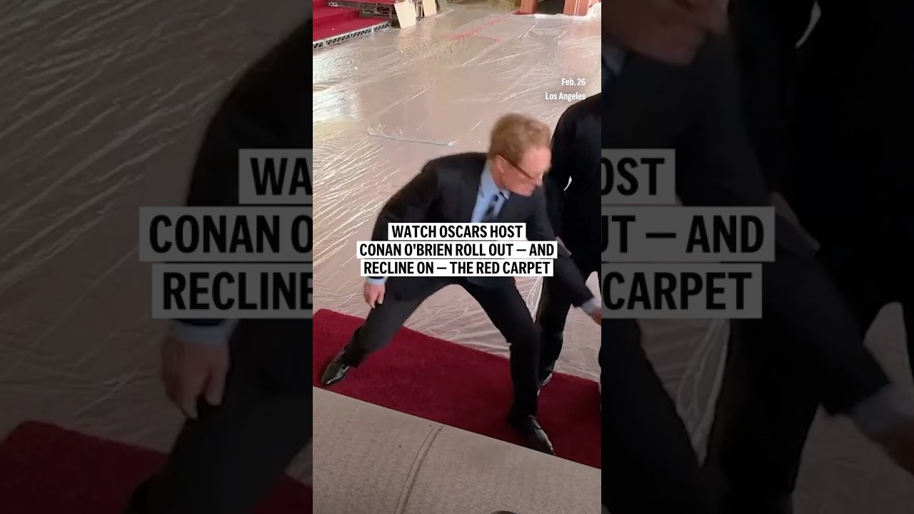 Watch Oscars host Conan O’Brien roll out — and recline on — the red carpet